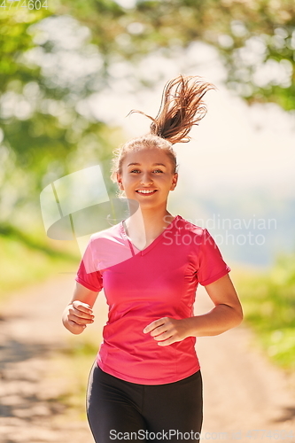 Image of woman enjoying in a healthy lifestyle while jogging