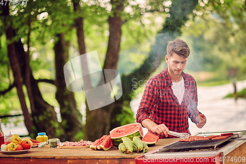 Image of man cooking tasty food for french dinner party