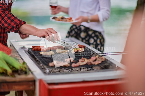 Image of man cooking tasty food for french dinner party