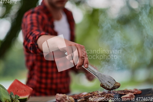 Image of man cooking tasty food for french dinner party