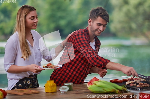 Image of friends having picnic french dinner party outdoor during summer holiday