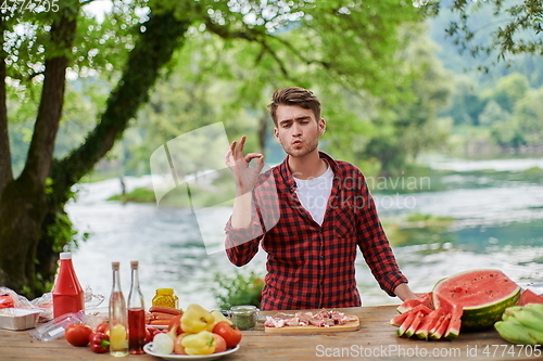 Image of man cooking tasty food for french dinner party