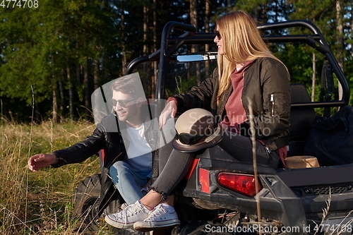 Image of couple enjoying beautiful sunny day while driving a off road buggy