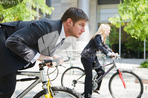 Image of Business people racing on bicycles