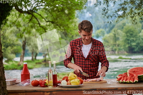 Image of man cooking tasty food for french dinner party