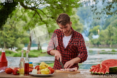 Image of man cooking tasty food for french dinner party