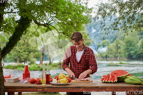 Image of man cooking tasty food for french dinner party