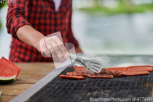 Image of man cooking tasty food for french dinner party