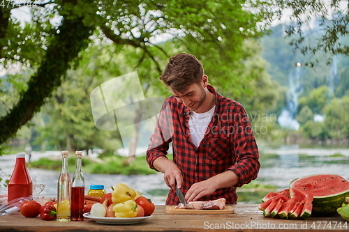 Image of man cooking tasty food for french dinner party