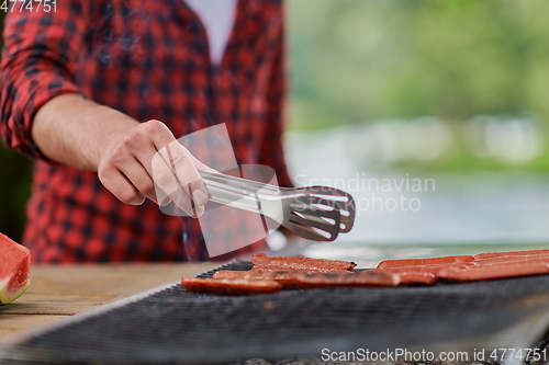 Image of man cooking tasty food for french dinner party