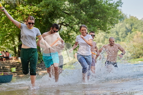 Image of group of happy friends having fun on river