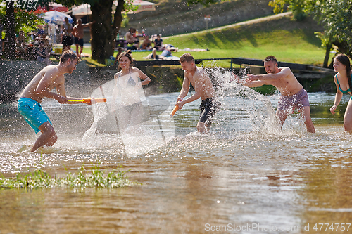 Image of group of happy friends having fun on river