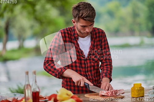 Image of man cooking tasty food for french dinner party