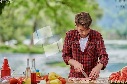 Image of man cooking tasty food for french dinner party