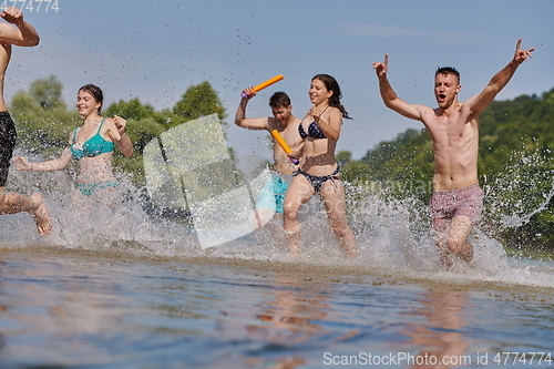 Image of group of happy friends having fun on river