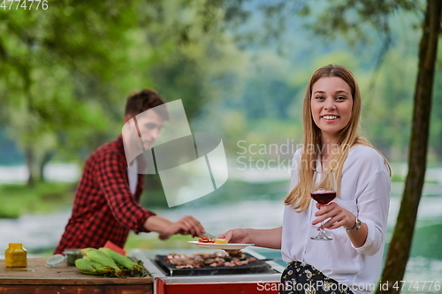 Image of friends having picnic french dinner party outdoor during summer holiday