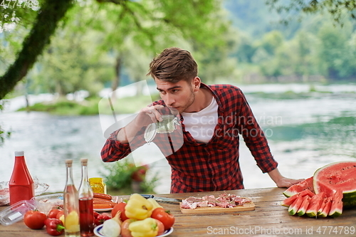 Image of man cooking tasty food for french dinner party