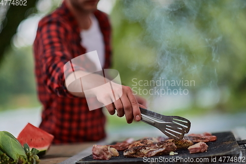 Image of man cooking tasty food for french dinner party