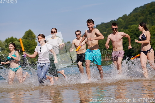 Image of group of happy friends having fun on river