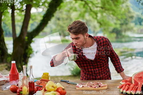 Image of man cooking tasty food for french dinner party