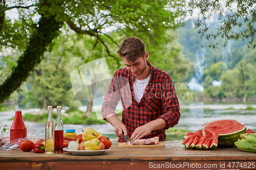 Image of man cooking tasty food for french dinner party