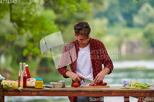 Image of man cooking tasty food for french dinner party