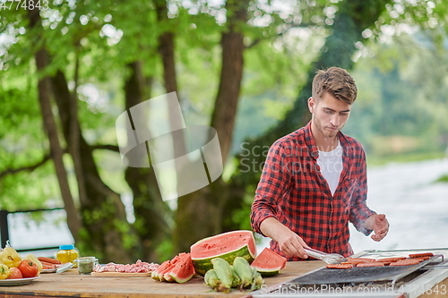 Image of man cooking tasty food for french dinner party