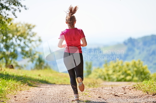 Image of woman enjoying in a healthy lifestyle while jogging