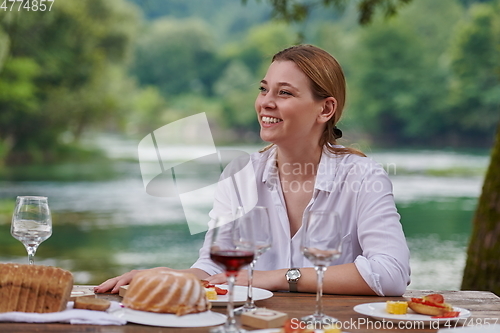 Image of Girlfriend having picnic french dinner party outdoor