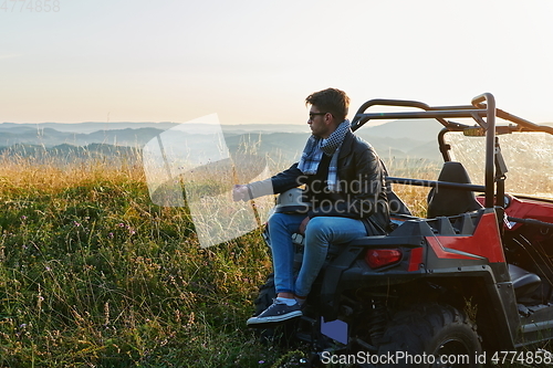 Image of man enjoying beautiful sunny day while driving a off road buggy car