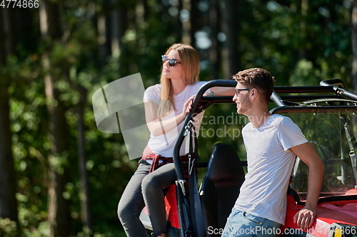 Image of couple enjoying beautiful sunny day while driving a off road buggy