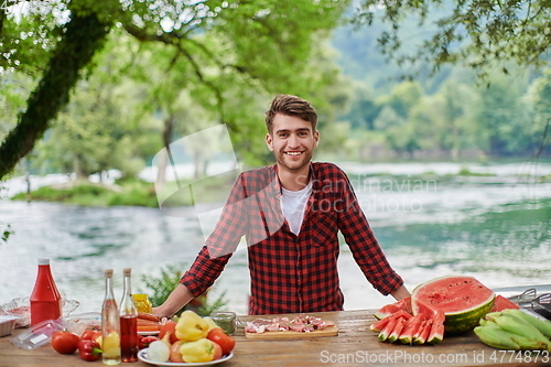 Image of man cooking tasty food for french dinner party