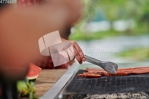 Image of man cooking tasty food for french dinner party