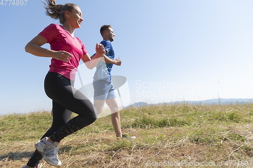 Image of couple jogging in a healthy lifestyle on a fresh mountain air