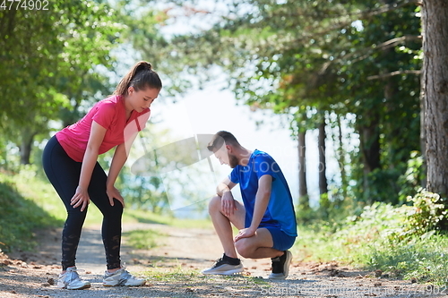 Image of couple enjoying in a healthy lifestyle while jogging on a country road