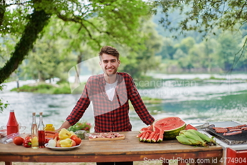 Image of man cooking tasty food for french dinner party