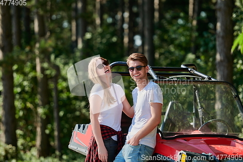 Image of couple enjoying beautiful sunny day while driving a off road buggy