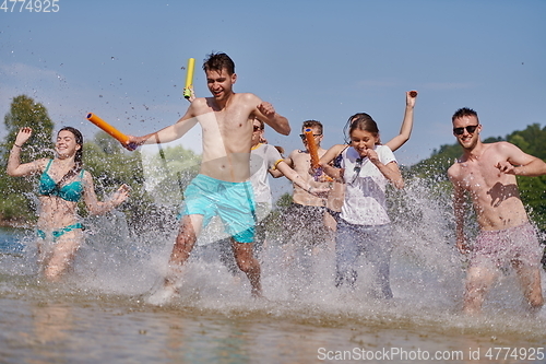 Image of group of happy friends having fun on river