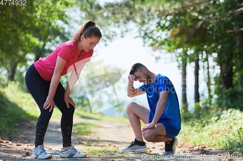 Image of couple enjoying in a healthy lifestyle while jogging on a country road