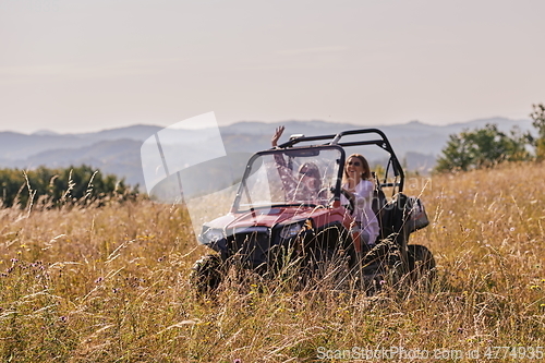 Image of girls enjoying a beautiful sunny day while driving an off-road car