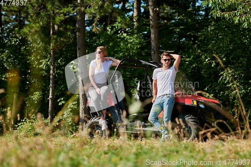 Image of couple enjoying beautiful sunny day while driving a off road buggy