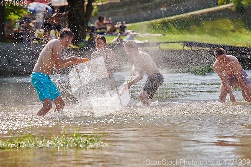 Image of group of happy friends having fun on river