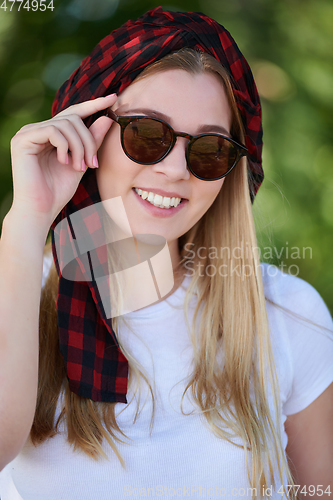 Image of portrait of beautiful, emotional, young woman in sunglasses.