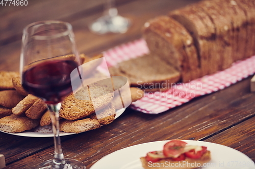 Image of composition with a glass of red wine and toasted bread