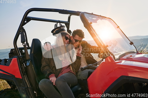 Image of couple enjoying beautiful sunny day while driving a off road buggy