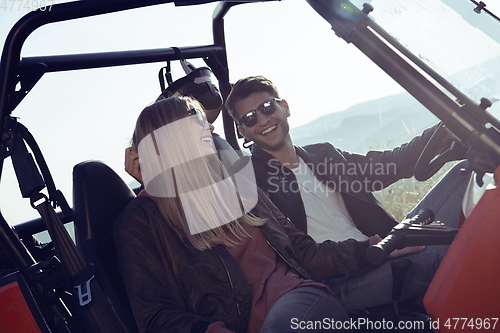 Image of couple enjoying beautiful sunny day while driving a off road buggy