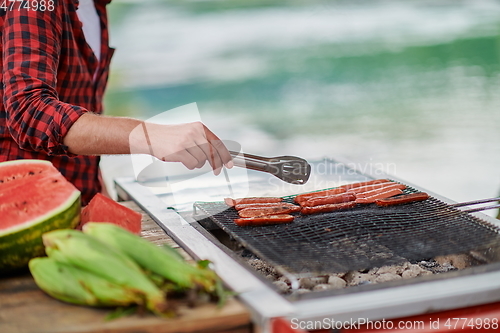 Image of man cooking tasty food for french dinner party