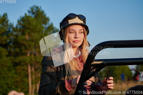 Image of girl wearing a helmet and enjoying a buggy car ride on a mountain