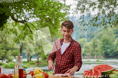Image of man cooking tasty food for french dinner party