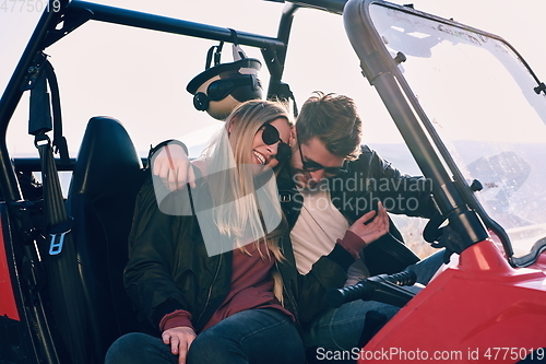 Image of couple enjoying beautiful sunny day while driving a off road buggy